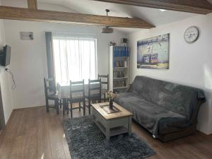 a living room with a couch and a table at Aqua Garden Junior Miercurea Ciuc in Miercurea-Ciuc