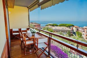 a balcony with a table and chairs and a view of the ocean at Maison Panorama - Portofino View in Lavagna