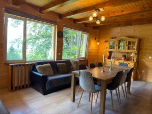 a living room with a table and a couch at Cabana Plai in Petroşani