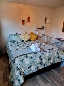 a bedroom with a bed with stuffed animals on it at Sun Republik Studio in Whitianga