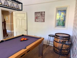 a room with a pool table and a barrel at Penybryn in Llandeilo