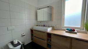 a bathroom with a sink and a mirror at MEERzeit-Norderney in Norderney +9 photos