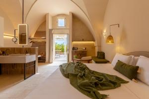 a bedroom with a bed and a sink in a room at Masseria Donna Menga - The Leading Hotels of the World in Torre Lapillo +124 photos