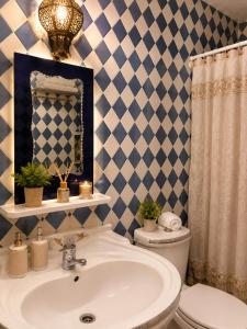 a bathroom with a sink and a toilet and a mirror at Cozy Guesthouse in Aourir near Tamraght in Aourir +18 photos