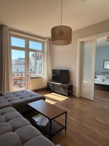 a living room with a couch and a tv at Apartamenty Rynek 7 in Cieszyn