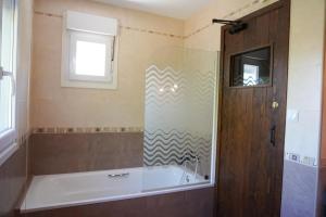 a bathroom with a bath tub and a window at Villa Pereza in Socueva +19 photos