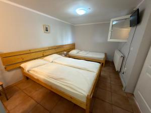 a small room with two beds in it at Cabana Plai in Petroşani