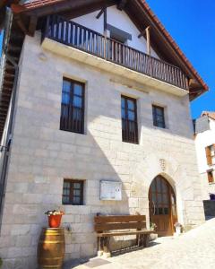 a building with a bench in front of it at Hostal Casa Otsoa in Ezcároz