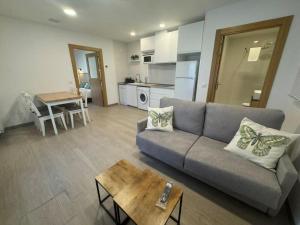 a living room with a couch and a table at Hostal Casa Otsoa in Ezcároz
