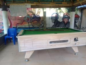 a pool table in a room with a mural at Palmgroove Hotel AND Bar, IDANYIN, IPERIN,OGUN STATE in Obisesan