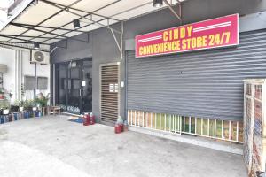 a store with a sign on the side of a building at Apartment MJ in Olongapo