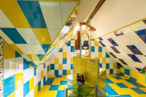 a bathroom with colorful tile floors and a toilet at Cherry Tree Sibiu in Sibiu +93 photos