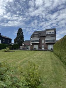 a house with a large lawn in front of it at Bellevue appartementen in Simpelveld