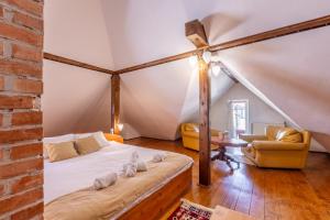 a bedroom with a bed and a table in a room at Cherry Tree Sibiu in Sibiu