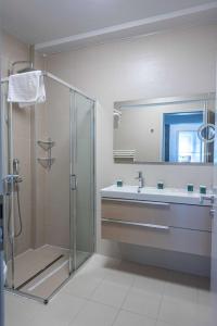 a bathroom with a shower and a sink and a mirror at Expecto Apartments in Sinaia +68 photos
