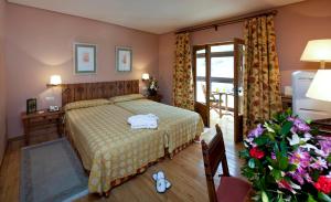 a bedroom with a bed and a table and a window at Parador de Fuente Dé in Fuente Dé