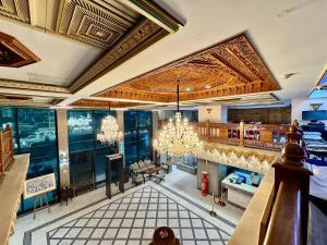 an empty restaurant with a chandelier hanging from the ceiling at Majliss Hotel Downtown in Rabat