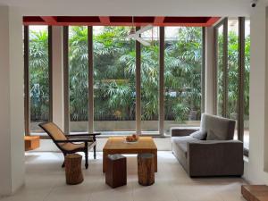 a living room with a couch and a chair and a table at CHERN Bangkok in Bangkok