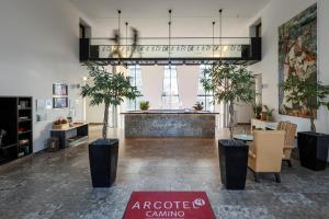 an office with potted plants in the middle of a room at ARCOTEL Camino Stuttgart in Stuttgart