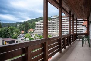 a balcony with a view of a city at Expecto Apartments in Sinaia