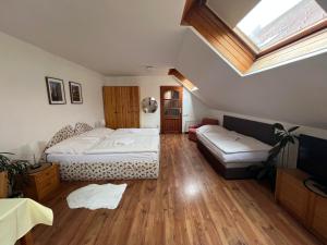 a bedroom with two beds and a skylight at ubytování U Šeniglů in Telč