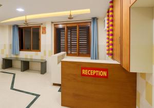 a reception room with a red registration sign on the wall at Hotel yogeshwar in Mahesāna