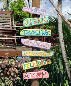a bunch of signs that are pointing in different directions at Casa Serena in Pipa
