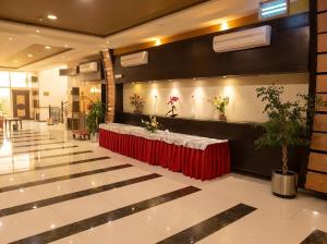 a lobby with a table with a red table cloth at Tulip Al Rawda Serviced Apartments in Riyadh