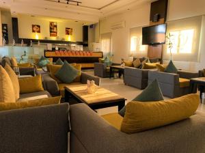 a large living room with couches and a television at Tulip Al Rawda Serviced Apartments in Riyadh