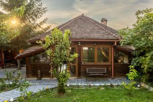 a house with a conservatory in a garden at Cherry Tree Sibiu in Sibiu