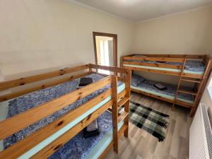 a room with three bunk beds and a mirror at Copa in Zeltweg +16 photos