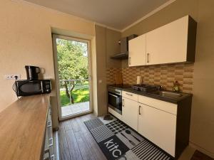 a small kitchen with a sink and a stove at Copa in Zeltweg