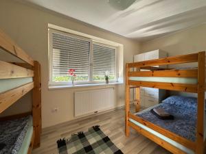 a bedroom with two bunk beds and a window at Copa in Zeltweg