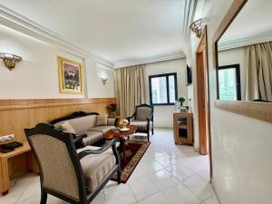 a living room with a couch and a table at Majliss Hotel Downtown in Rabat