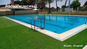 a large swimming pool with blue water in the grass at La Moreneta in Casas de Haro