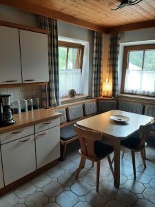 a kitchen with a table and a table and chairs at Alpine cottage with exceptional view in Mayrhofen