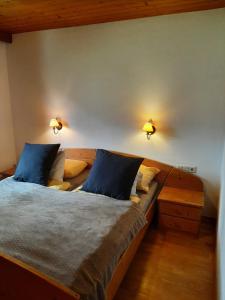 a bedroom with two beds and two lights on the wall at Alpine cottage with exceptional view in Mayrhofen