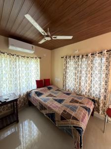 a bedroom with a bed and a ceiling fan at Hayath Homes in Athirappilly