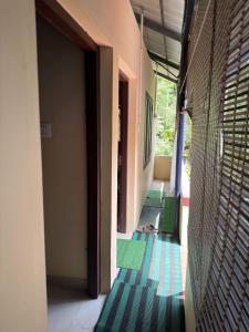 a hallway with green and blue flooring in a building at Hayath Homes in Athirappilly