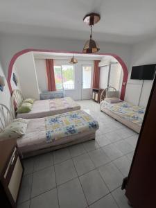 a bedroom with two beds and a mirror at Onur Motel in Bozdoğan