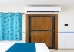 a door in a room with a blue curtain at Hotel yogeshwar in Mahesāna