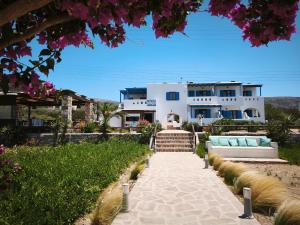 a house on the beach with a couch in front of it at Ammoudia Studios in Agiassos