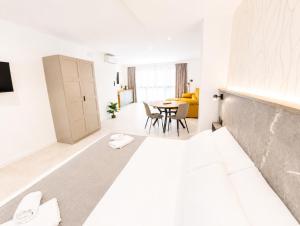 a white room with a bed and a table at AH Rentals in Vinarós
