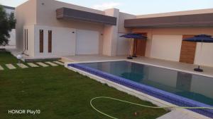 a house with a swimming pool in the yard at Elin house in Hammamet