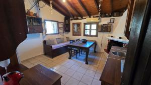 a kitchen and living room with a table and a couch at Lekania House in Káto Nisí
