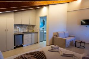 a living room with a couch and a kitchen at PERDIKA's HORIZON in Perdika
