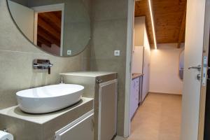 a bathroom with a sink and a mirror on the wall at PERDIKA's HORIZON in Perdika +23 photos