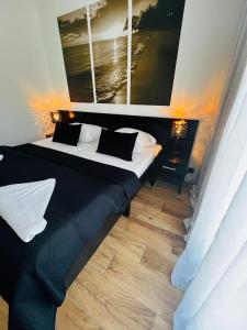 a bedroom with a bed and two pictures on the wall at Tesao Room by Dworek Marino in Grzybowo