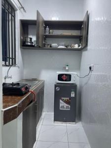 a small kitchen with a sink and a stove at Bellah Homes in Bamburi