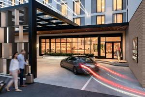 a car driving in front of a building at AC Hotel by Marriott Denver RiNo in Denver